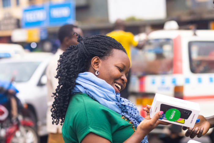 Kenyan woman receiving new smart phone